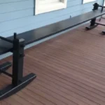 Lady paints rubber doormats black and glues them onto distressed wooden frames. Everyone is copying this idea for their patio.