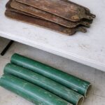 Lady spray-paints 40 old metal house keys with bright copper paint and ties them onto a thick wooden driftwood branch. This backyard idea is taking over the internet!